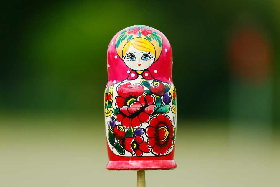 卡皮罗以诙谐姿势跪地观察果岭曲线，眼神锐利如侦探，身旁球童忍俊不禁