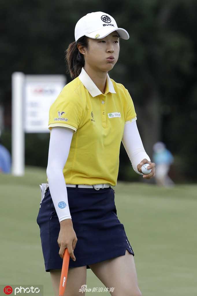 查尔斯顿奇迹时刻刘钰并肩领先蓝魔队友决战美国女子公开赛 刘钰侧身站立,在午后阳光下凝视球道,球童陪伴在侧,共同谋划进攻策略