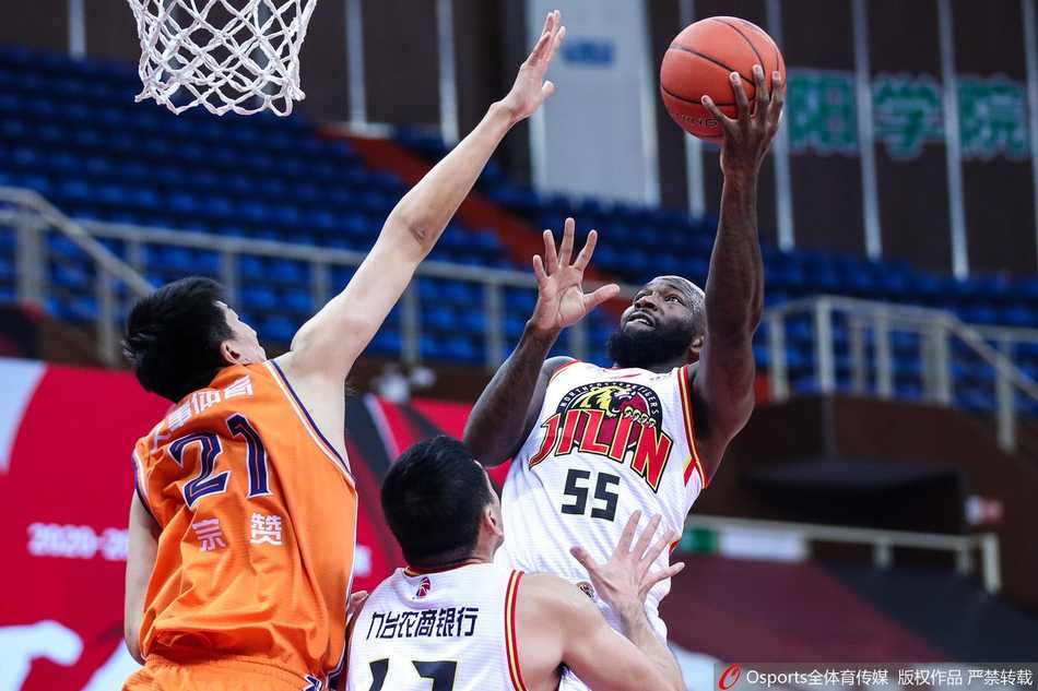 赛后，吉林队球员们围聚在场地中央，庆祝这场来之不易的险胜，而远处的上海队球员则神情落寞地走向球员通道，背景板上赞助商的logo记录着这场商业与竞技并重的职业联赛。