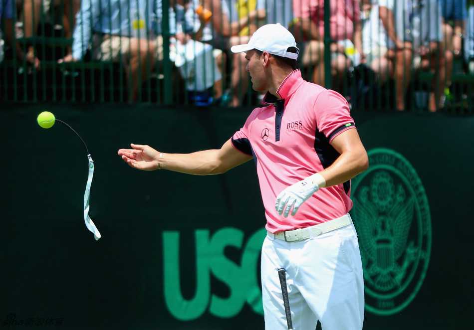 马丁·凯梅尔正在整理他的训练装备，包括用于特殊练习的网球，每一件工具都承载着球员对技术精益求精的追求。