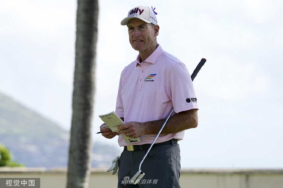 比赛现场观众聚集在果岭周边，聚精会神地观看球员推杆，氛围紧张而热烈。