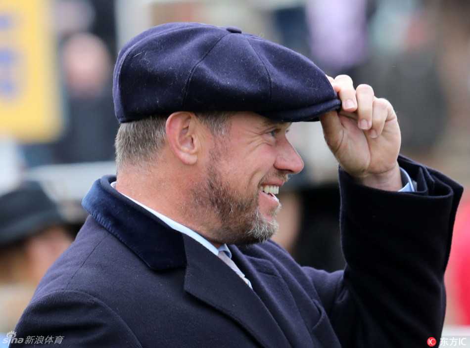 夕阳的余晖为现场镀上一层金色，维斯特伍德夫妇在温暖的光线下继续观赛，身影融入节日尾声依然热烈的人群中。