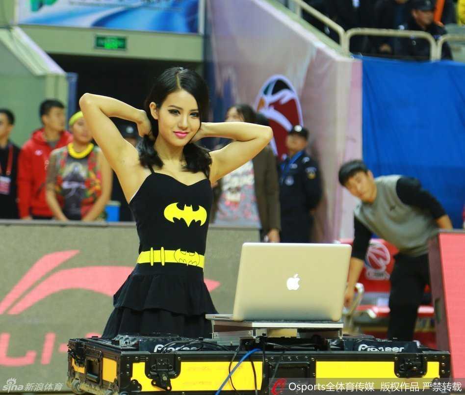 光影交错中，美女DJ专注地调试着设备，动感的音乐仿佛正从她的指尖流淌而出，她与身后的灯光秀共同构成了一幅现代感十足的赛场画面。