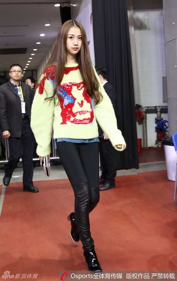 坐在一旁的陈露与友人热聊，她身着一袭优雅服饰，侧身交谈时笑容灿烂，展现了模特出身的良好气质与亲和力，成为赛场边一道靓丽的风景线。