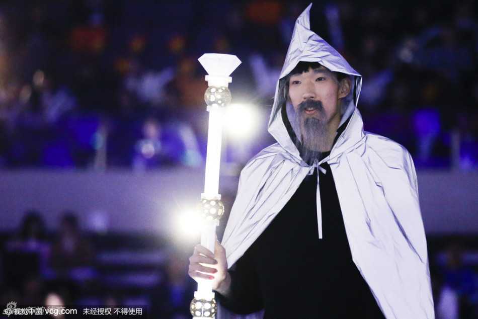 周琦的奇幻变身:从“大魔王”到白胡子魔法师 周琦与多名舞者同台表演,他手持金色魔杖神情专注,巨大的假胡子随着头部转动而微微摆动,营造出神秘而庄重的舞台氛围。