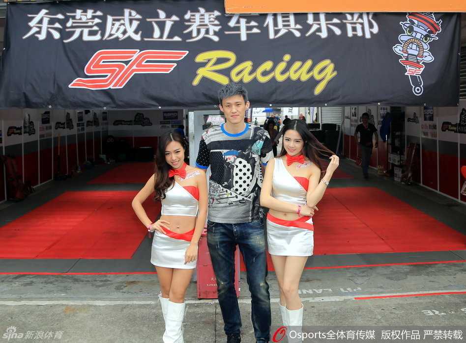 周鹏专注凝视赛场，眼神中透露出对赛车的热爱与执着