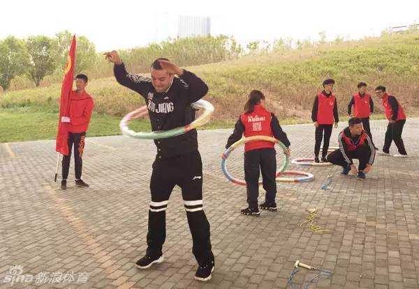 风雨同行,为爱酷跑:西热力江与阿不都的公益征途 阿不都沙拉木在为篮球签名,神情专注而认真,笔尖在球面上缓缓移动,寄托着对球迷和公益的深情。