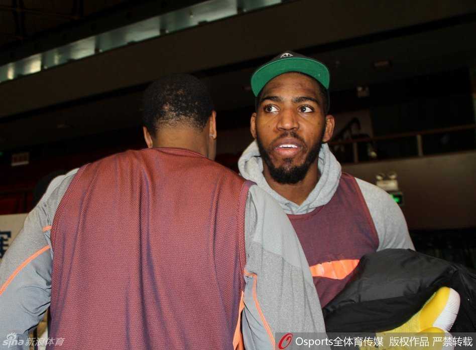 两位CBA外援约什·史密斯与贾森·汤普森在赛前热身时碰面，两人面带笑容，互相致意，仿佛许久未见的老朋友。