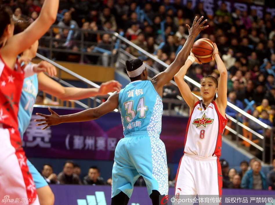 北京女篮外援福尔斯在八一队内线群中高高跃起，单手将球劈入篮筐，展现篮下绝对统治力。