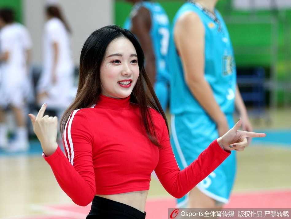 WCBA联赛江苏主场激战大庆 篮球宝贝热舞点燃冬日赛场 镜头拉近,一位领舞的宝贝正对着观众席绽放自信的笑容,她手中的花球在空中划出优美的弧线,仿佛在邀请全场观众一起加入这场篮球派对。