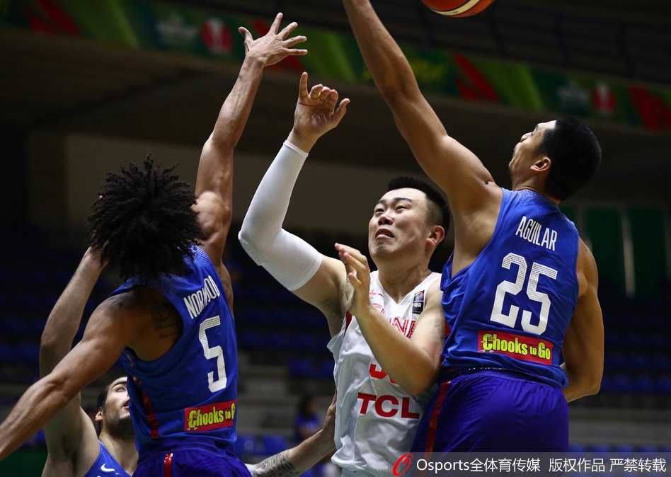 胡金秋高高跃起，从两名菲律宾球员头上摘下关键篮板，落地瞬间眼中满是坚毅