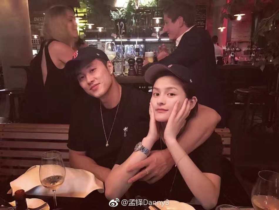 从“小韦德”到冠军领队:孟铎的篮球路与他的冠军妻子 孟铎与女友身着休闲装,在户外留下温馨合影,两人举手投足间充满默契,展现了运动员情侣的活力与柔情。