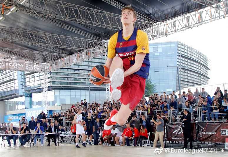 伊斯坦布尔四强赛的蓝色狂欢:马尔马拉球迷专区全记录 一位身穿土耳其球队外套的小球迷踮起脚尖,目光穿越人群,紧紧追随着场内正在进行的趣味投篮赛,纯真的脸上写满了对篮球世界的向往。