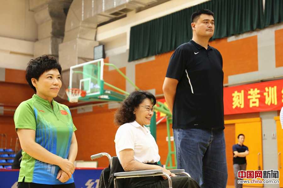 共享健康与残运梦想 张海迪姚明邓亚萍陪残疾人朋友乐享健身周 篮球巨人姚明微笑着站在轮椅篮球选手中间,他俯下身子与坐轮椅的运动员平视交谈,巨大的身高差构成了画面中最温柔的尊重与鼓励