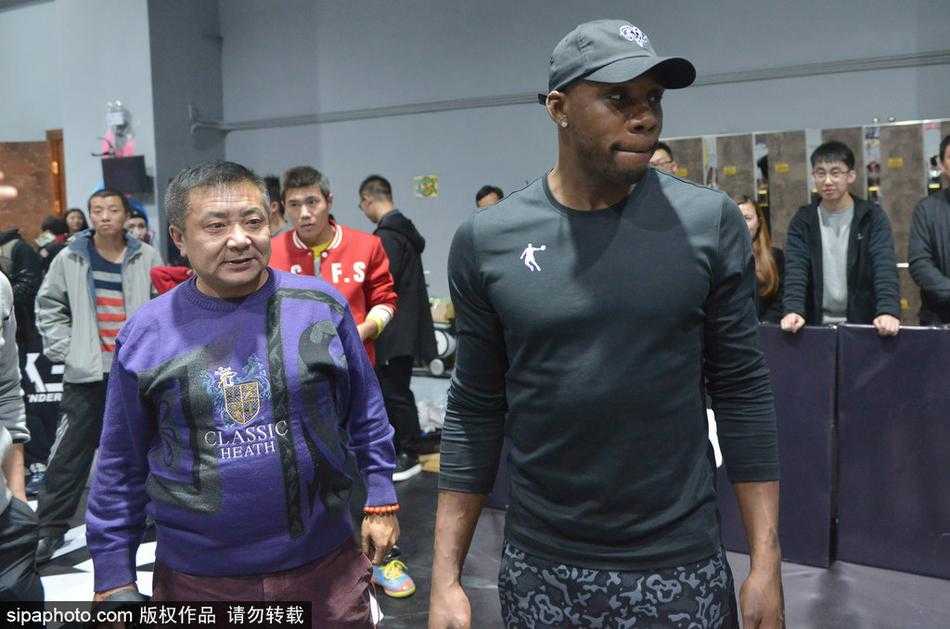 哈德森沈阳秀三分教女球迷运球 引爆篮球嘉年华 哈德森扬手命中三分,篮球在空中划出优美弧线,对面的男球迷举着篮球跃跃欲试,现场气氛热烈。