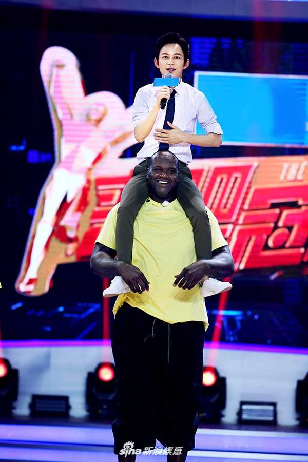 综艺现场奥尼尔如同一个巨大的开心果，将身材娇小的宋茜轻松揽住，两人互动表情夸张有趣，充满了跨次元的喜剧感