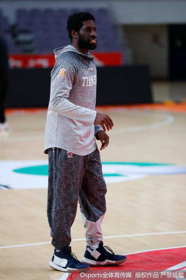 天津荣钢队全体队员在训练馆中围成一圈，相互鼓劲呐喊，斗志昂扬，团队气氛热烈而专注。