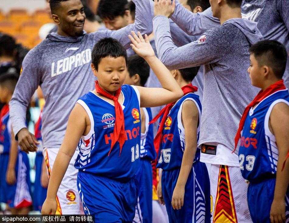 小小少年闯入CBA赛场,专注眼神抢镜成最萌风景线 几位小小篮球迷并排而坐,聚精会神地观看比赛,其中一位孩子不自觉地模仿着场上球员的动作,小手微张,似乎正准备接下队友的传球。