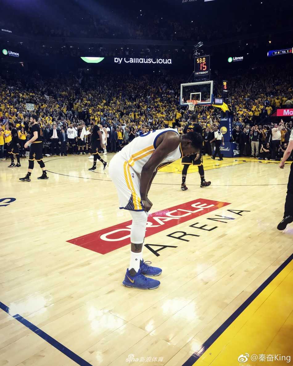 夺冠后的KINGS队在赛场合影，秦奋站在队友中间，手捧冠军锦旗，尽管面带疲惫却难掩喜悦之情，白色的冠军T恤映衬着他们此刻无上的荣耀。