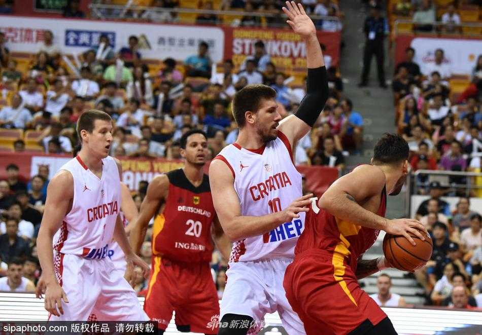 德国队全队在颁奖台上高举冠军奖杯，金色的雨再次飘落，背景是鲜艳的五星红旗与国际篮联旗帜，这一刻体育的荣光跨越了国界。