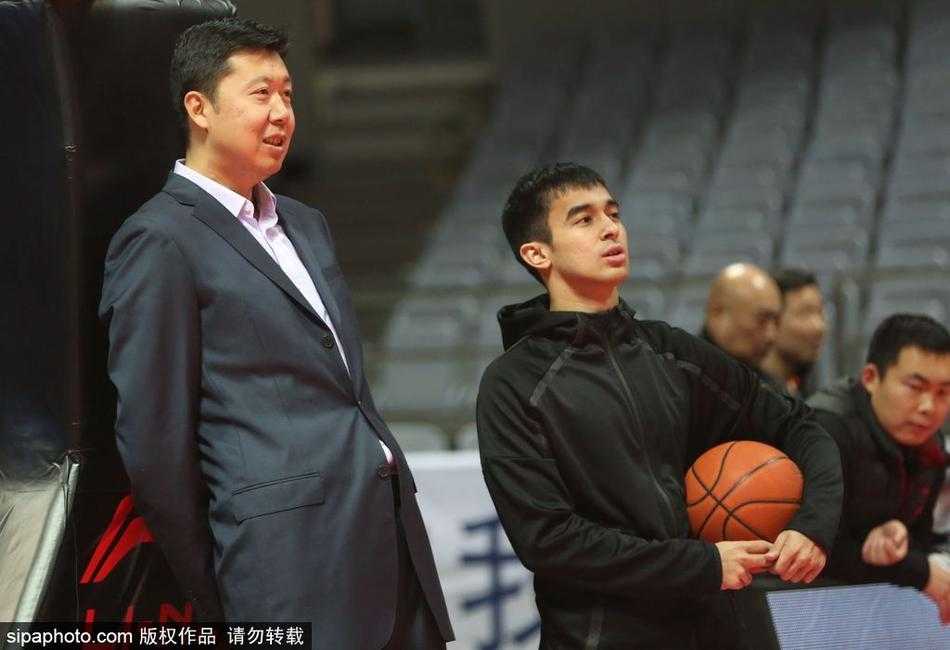 热身场地中央，王治郅弯下腰仔细捡起一颗滚落的篮球，动作自然而随意，仿佛他从未离开过这片热爱的赛场，此刻他不是什么名宿，只是一个心系篮球的普通守望者。