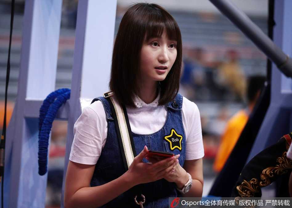 刘美双手轻轻托腮，全神贯注地注视着赛场内的一举一动，精致的五官和优雅的坐姿让她在看台上自成一道风景，眼神中透露出对比赛的关切。