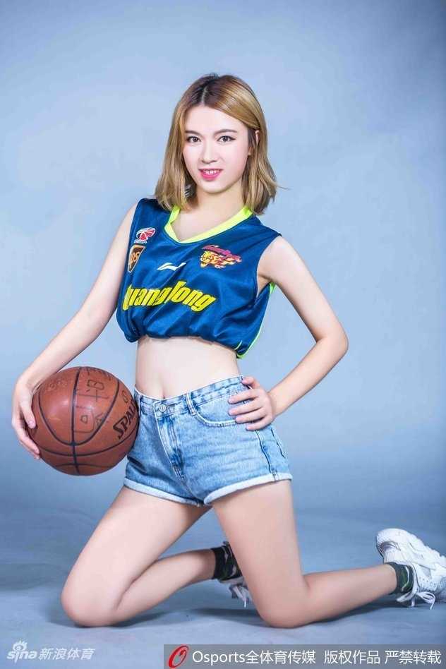 篮球宝贝|南粤热浪中的助威女神 篮球宝贝侧身站立,广东队球衣下的身材曲线玲珑,动感十足