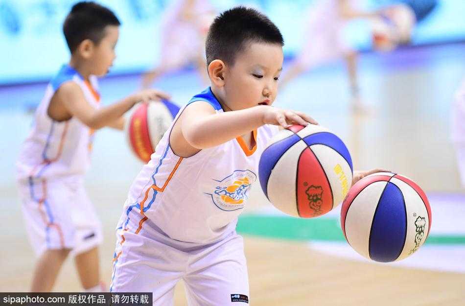 篮球萌娃燃爆CBA赛场,中场表演成冬日最暖风景 镜头拉近,一位领舞的小男孩双手同时运球,表情酷酷的,仿佛在告诉全世界:未来篮球巨星就是我!身后的队友们则排着整齐的队形为他加油。