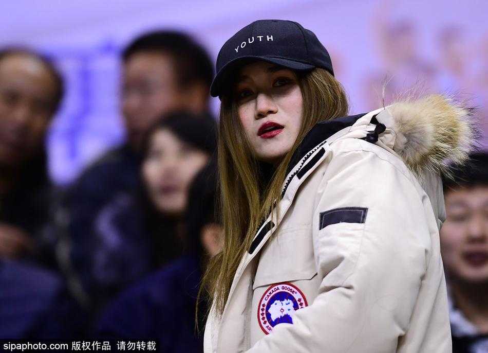 辽疆大战之外的风景 本溪赛场美女球迷巧笑嫣然 一位长发披肩的美女球迷坐在看台上,她身姿挺拔,穿着时尚的黑色外套,正全神贯注地望向赛场方向,眼神中带着对主队辽宁男篮的无限关切,仿佛下一秒就要为球员的精彩表现起身呐喊。