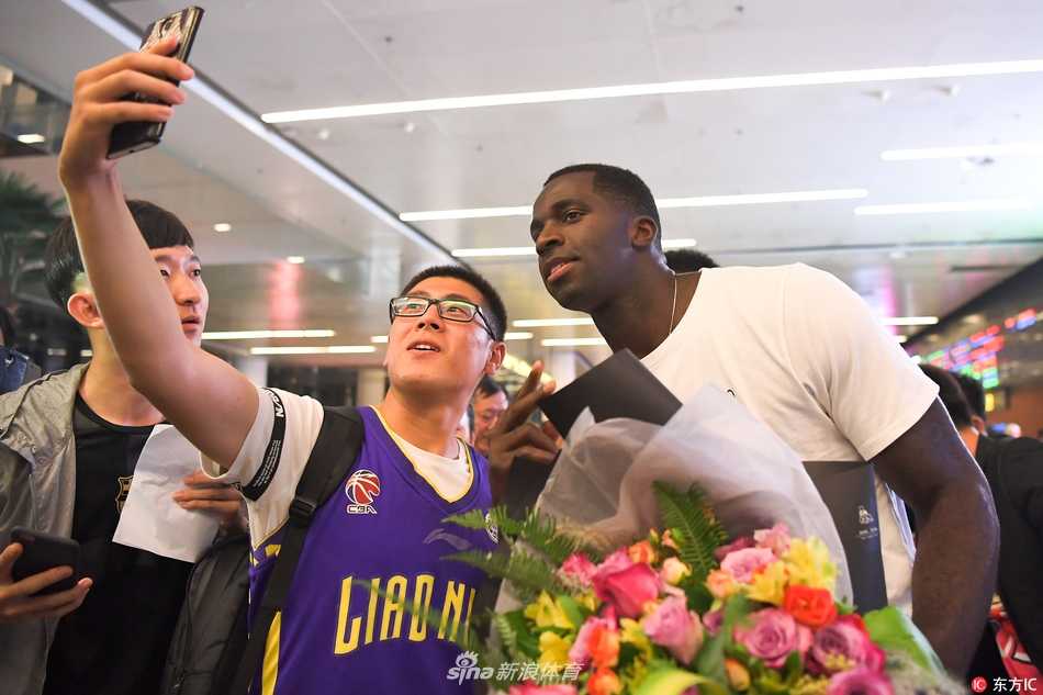 在闪光灯的包围下，巴斯耐心地给身旁的小球迷签名，这份亲民举动让他迅速拉近了与异国他乡支持者的距离。