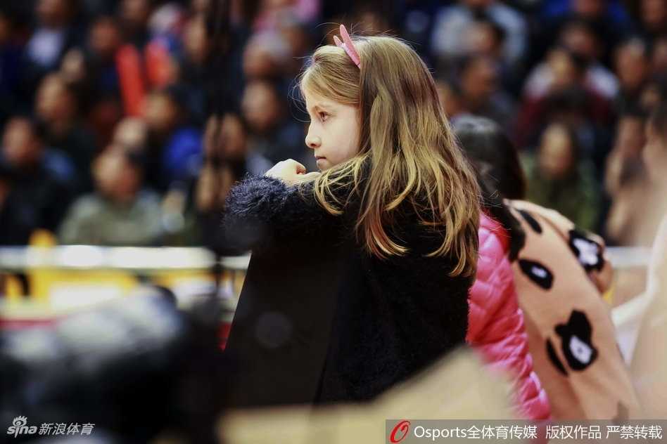 莫泰尤纳斯的小儿子戴着毛线帽，在母亲怀里好奇地东张西望，球馆的喧嚣对他来说更像是新奇的交响乐。